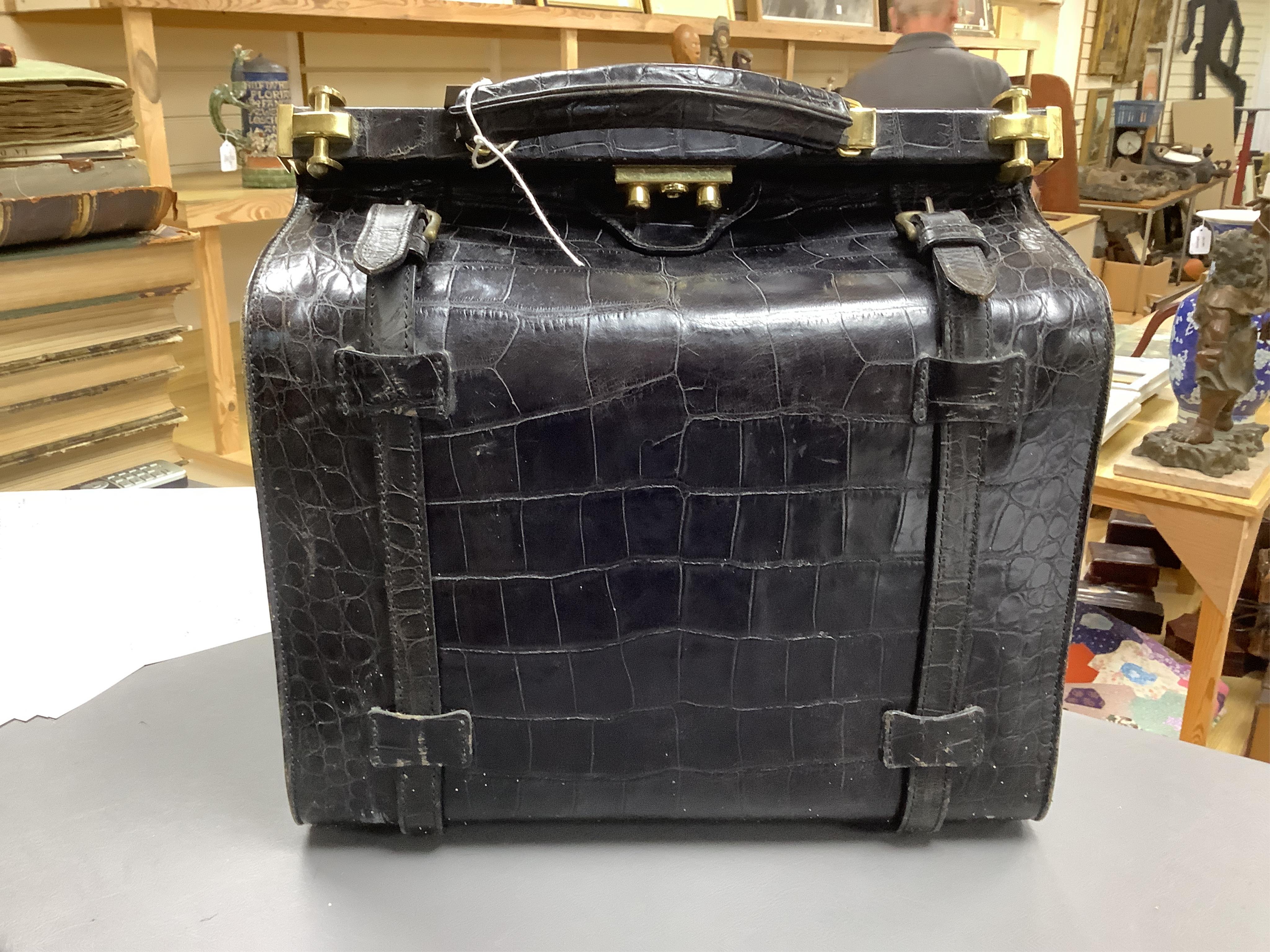 A 1940’s ladies crocodile skin Gladstone bag with gilt metal hardware, 34cm wide